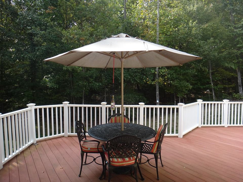 Composite deck with white railing and patio furniture