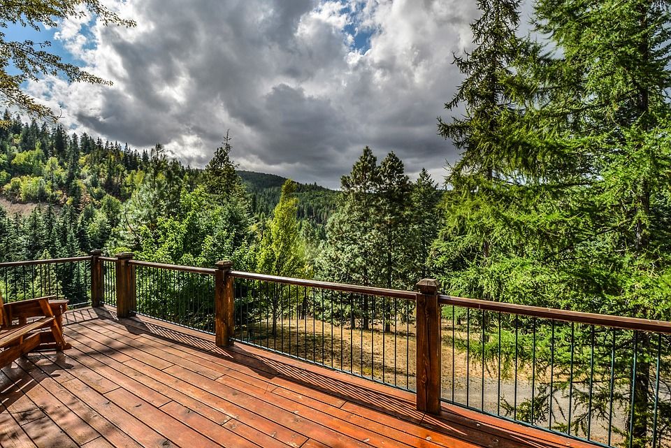 Wood deck with cable railing overlooking trees