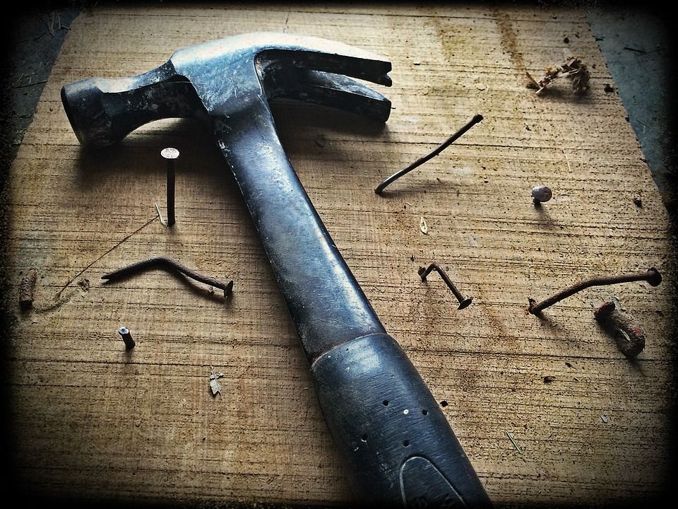 Hammer and nails on a workbench