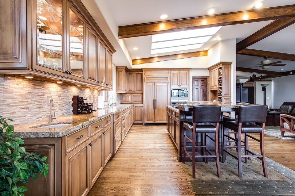 Remodeled kitchen with wood cabinets and island